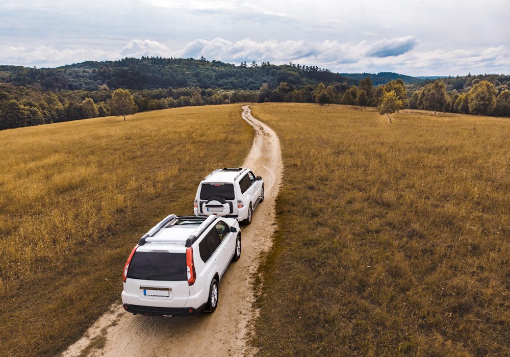 travel concept. two suv car riding by trail road. adventure time